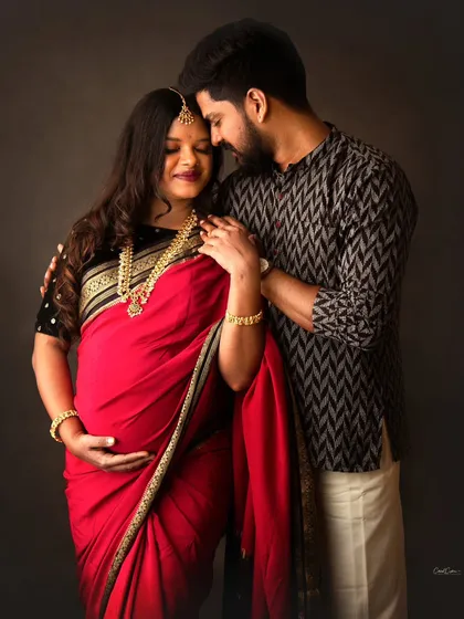 I had the absolute honor of capturing this tender moment between two renowned photographers. This traditional couple's maternity portrait, with them in a beautiful red saree and kurta, shows the deep connection and quiet joy of expecting parents.