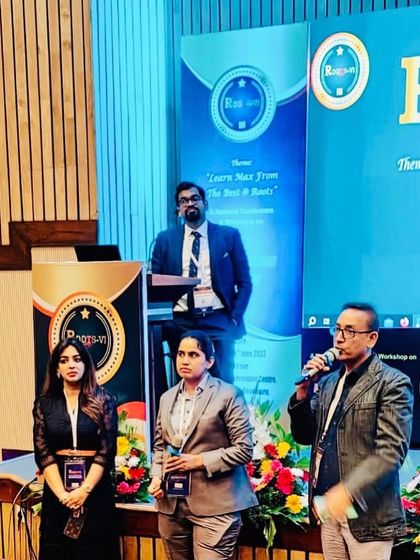 On stage with fellow experts at the Roots 2023 conference. Collaborative discussions are key to refining techniques and improving patient outcomes in aesthetic dermatology.