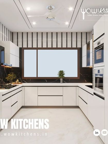 A closer look at the details of the black and white kitchen, highlighting the sleek black handles on the white cabinets and the beautiful veining in the black marble backsplash.