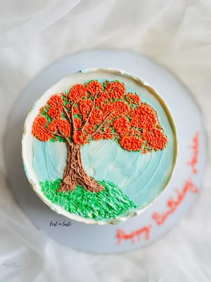 This cake is a tribute to the beautiful Gulmohar tree. The design is hand-piped with colored buttercream to create a miniature painting you can eat.