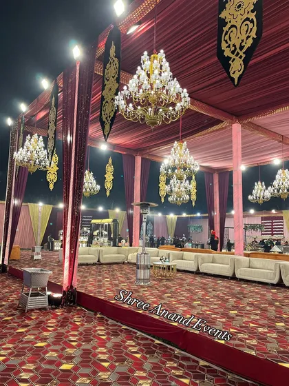 An expansive view of the event space, showcasing the grand scale of our tenting, multiple chandeliers, and spacious seating arrangements.