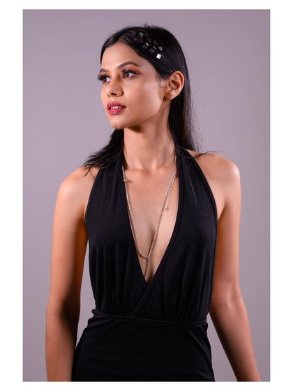 A three-quarter shot that highlights the backless design of the dress.