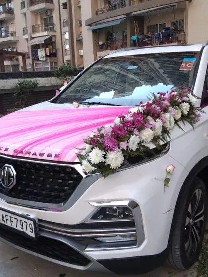 Another angle of the MG Hector wedding car decoration, showing the fresh flower bouquet and pink fabric. I ensure every detail is perfect for your special day.
