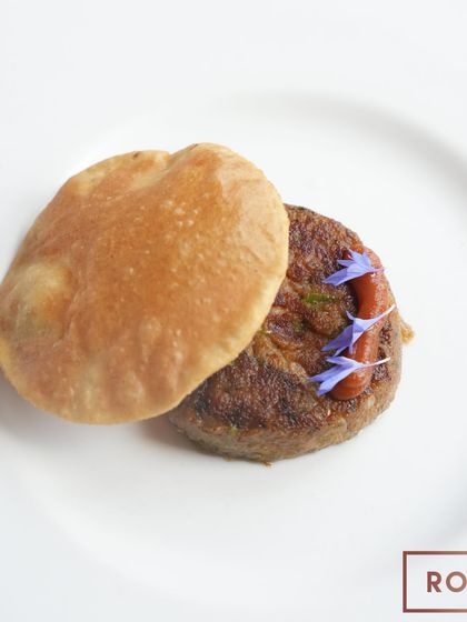 A perfectly plated Shami Kabab and Poori, a dish that translates to "The Taste of the Soul" and captures the essence of Lucknowi cuisine.