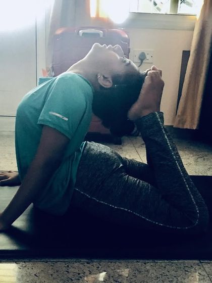 This is Rajakapotasana (King Pigeon Pose), a deep backbend that requires significant flexibility. It opens the heart and throat, activates the nervous system, and calms the mind.