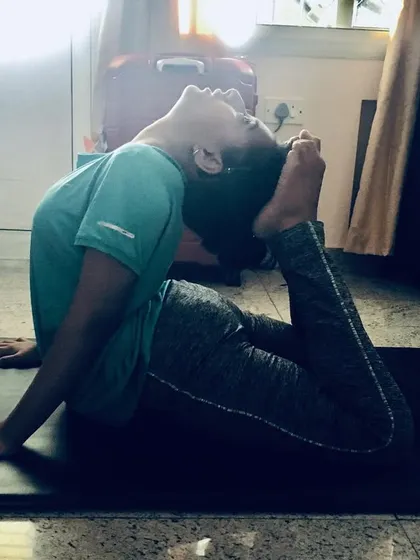 This is Rajakapotasana (King Pigeon Pose), a deep backbend that requires significant flexibility. It opens the heart and throat, activates the nervous system, and calms the mind.