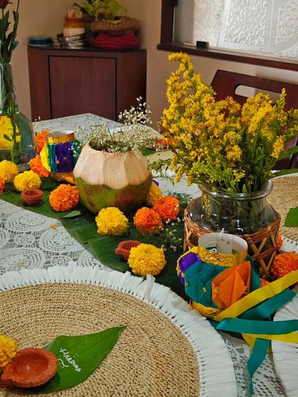 A festive tablescape for Diwali, with marigolds, diyas, and beautiful centerpieces. The ambiance is just as important as the food in creating a complete experience.