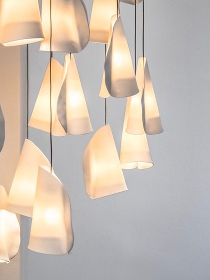 A close-up of the Bocci 21 pendants, showing the subtle variations in shape and the delicate translucency of the porcelain.