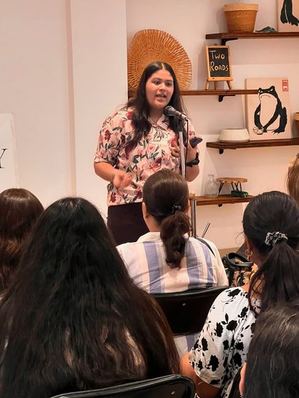 A young artist passionately performing at our open mic. We are dedicated to providing a stage for emerging talent from all age groups.