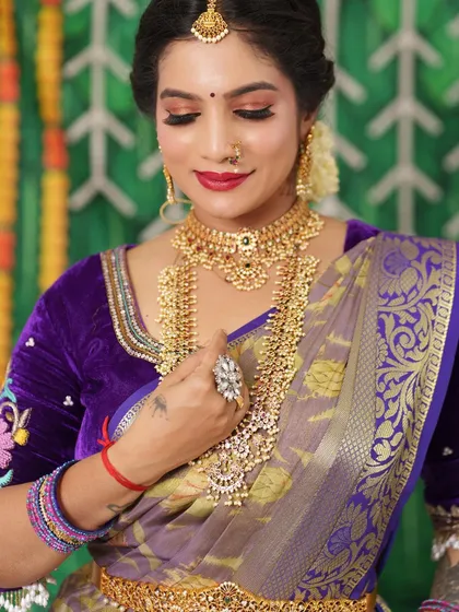 A close-up of the layered antique necklaces, showing the intricate craftsmanship.