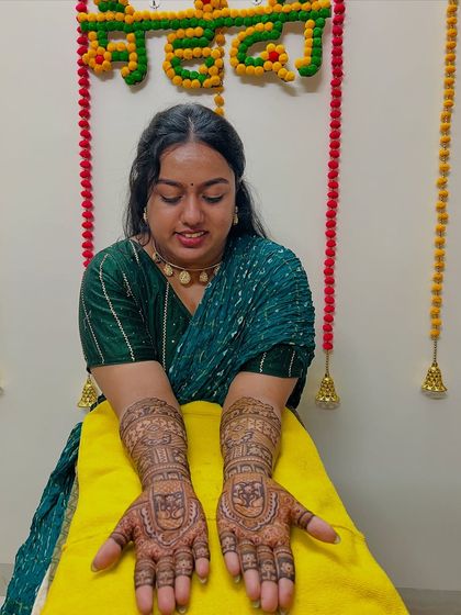 A happy client showcasing her engagement mehndi. We love being a part of our clients' special moments.