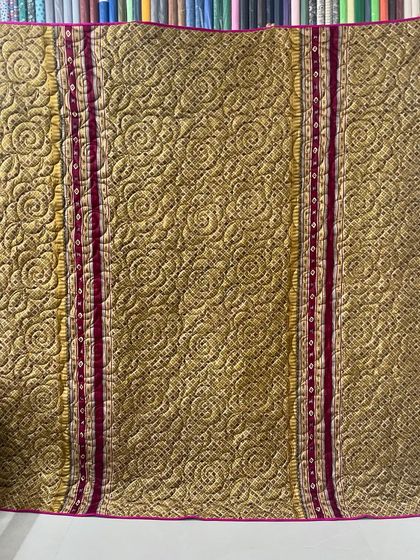 The reverse side of the 'H' initial saree quilt, displaying a stunning gold and red pattern.