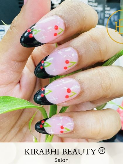 Another angle of the cherry French manicure, showing how the design looks against a natural background. The details really pop.