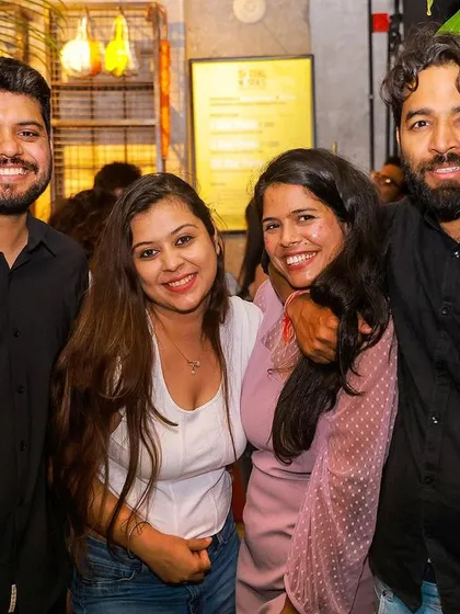 Friends gathered and smiling for the camera. The social aspect of my parties is just as important as the music.