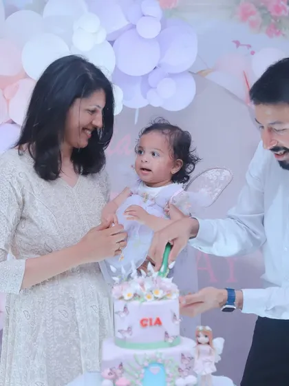 The cake cutting is a classic milestone, and we make sure to capture it with all the excitement and love in the room. This is a memory of a family celebrating their daughter's first birthday together.