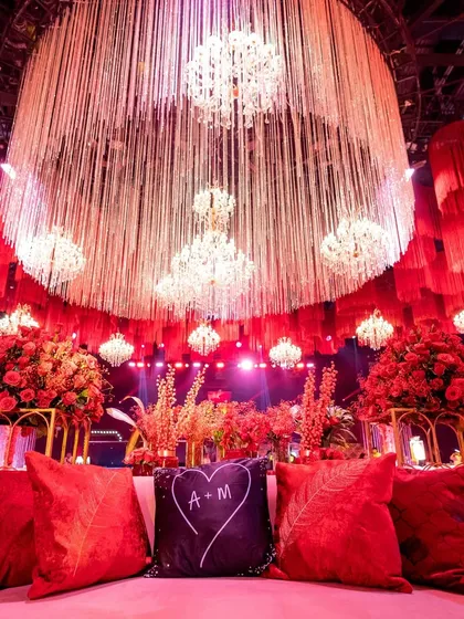 A duplicate of image 36, this view from the main couple's sofa shows their personalized cushion and the stunning vista of the decorated hall.