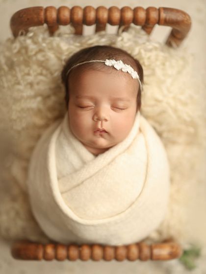 Even at two months old, we can achieve beautiful, sleepy portraits. This sweet girl was colicky, but with patience and my calming techniques, we captured this serene moment in just 90 minutes.