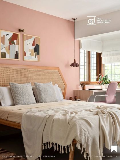 A featured image of the peach-toned guest bedroom, showcasing the rattan headboard and cozy study nook by the window, creating a warm and personal space.