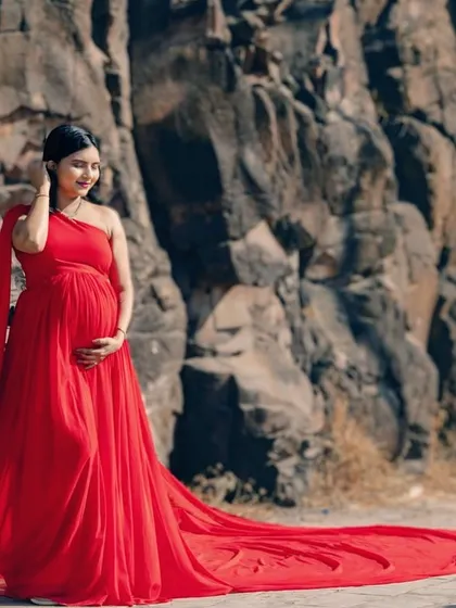 Celebrating the journey to motherhood. My rental gowns are also perfect for maternity shoots, designed to be comfortable while making you look and feel absolutely radiant, like this mom-to-be in our classic red trail gown.