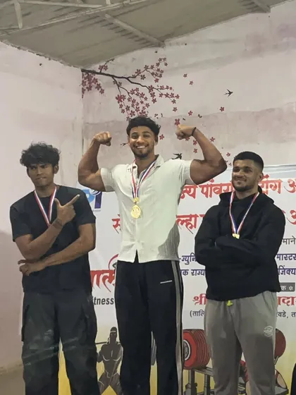 An athlete celebrating his gold medal at the Maharashtra State Championship. A dominant performance with a 605kg total in the 83kg junior category.