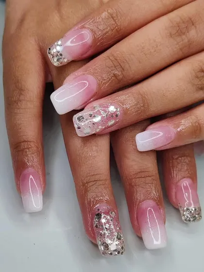A stunning ombré manicure with chunky silver glitter accents for a bold and sparkling party look.