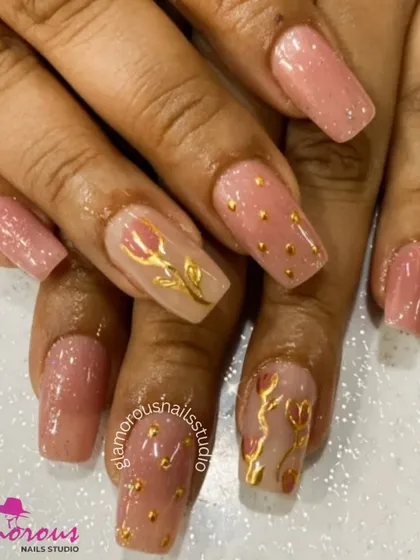 An elegant and artistic set. On a shimmery pink base, we hand-painted beautiful golden tulips and added tiny gold studs for a touch of texture. This design is a perfect example of wearable art.