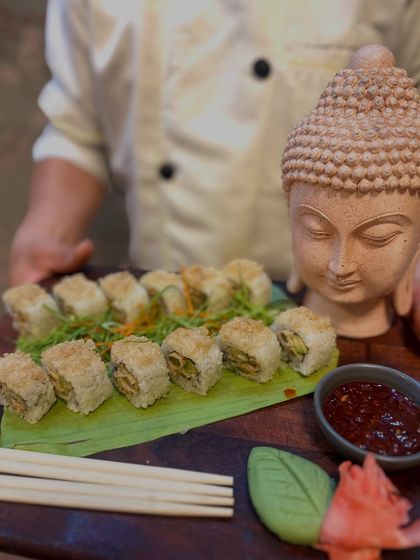 A clearer view of our expertly rolled sushi, presented on a banana leaf for an authentic touch. Each roll is crafted with fresh ingredients and served with spicy dipping sauce.