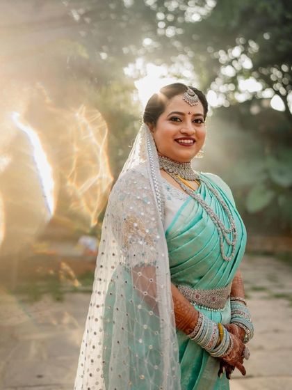 A beautiful, sun-kissed shot of a happy bride on her wedding day, with her intricate mehendi adding to her glow.