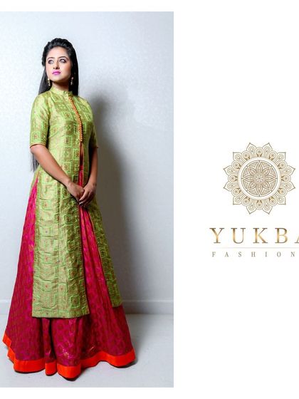 A three-quarter view of the green and pink gown, highlighting the elegant silhouette.