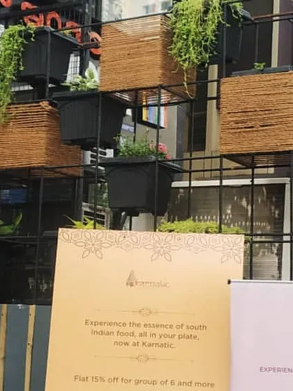 A wider view of the storefront vertical garden. The modular design allows for creative arrangements and makes it easy to care for the plants, adding a welcoming touch of nature to the entrance of the business.