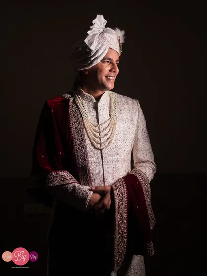 A portrait of the groom, Pratik, looking happy and dashing in his wedding sherwani.
