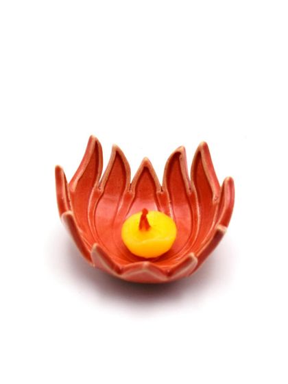 A single, vibrant orange lotus diya, captured against a clean white background. This image highlights the simple elegance and craftsmanship of our festive lighting options.