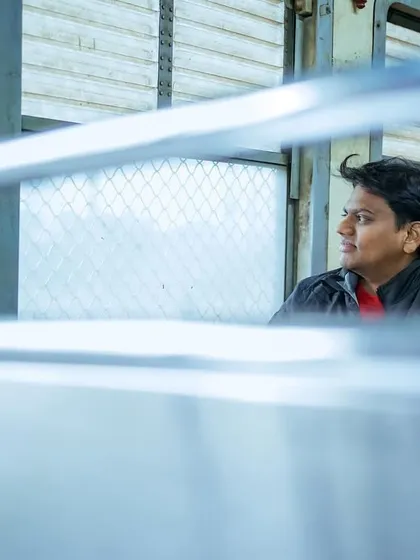 A pre-wedding shoot can happen anywhere that's special to you, even a Mumbai local train. I framed this shot through the window bars to create a sense of a private, stolen moment amidst the public journey.