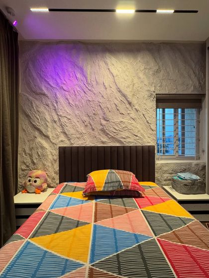 The same stone texture was used for the headboard wall in the master bedroom. The raw, natural feel of the wall is a beautiful contrast to the soft furnishings, and it looks amazing with colored mood lighting.