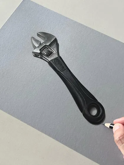 This is a realistic drawing of a spanner. Capturing the texture and reflections of worn metal is a great exercise for any artist.