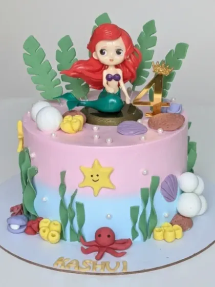 An enchanting mermaid cake for a 4th birthday. This choco-vanilla cake features an underwater scene with a cute mermaid, shells, and sea plants, all made from scratch.