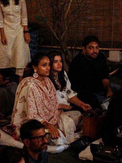 An audience enjoying an evening of ghazals. The informal seating and relaxed environment are designed to make everyone feel comfortable and connected to the performance.