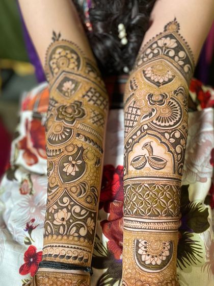 A pair of arms with non-symmetrical but complementary designs, showing creative freedom.