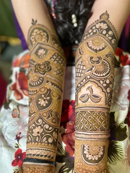 A pair of arms with non-symmetrical but complementary designs, showing creative freedom.