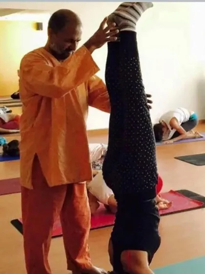 In Sirsasana, or headstand, proper alignment is paramount. I provide physical cues and support to ensure the student is stable and safe, allowing them to experience the full benefits of this king of asanas.