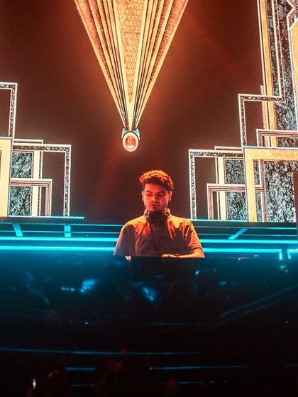 A powerful shot of me at the console, framed by the incredible stage production and lighting. This was during a massive concert event.