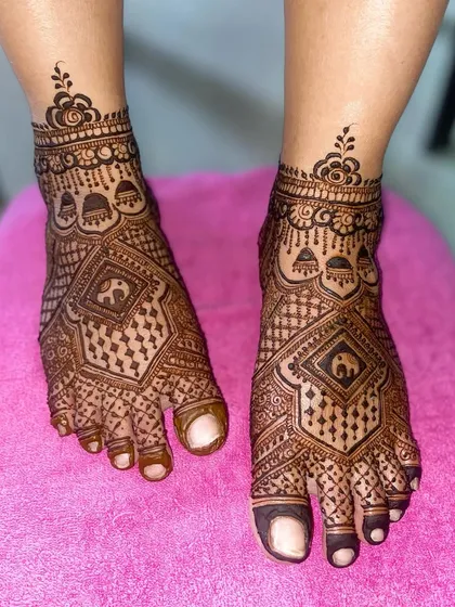 A close-up of the geometric foot design, showing the fine details of the elephant motif inside the diamond pattern.