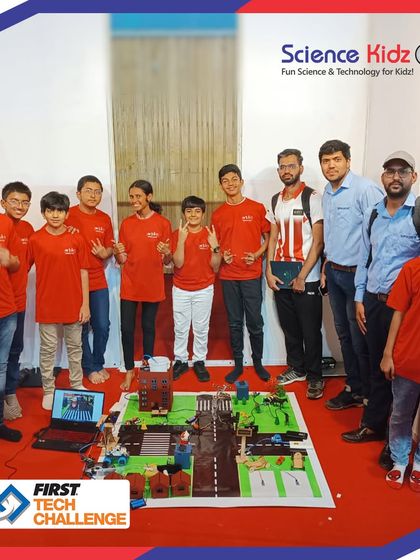 Our team proudly standing with their 'Soul City' project, a detailed model of a smart city featuring automated traffic, sustainable energy solutions, and more, built for the FTC India Championship.