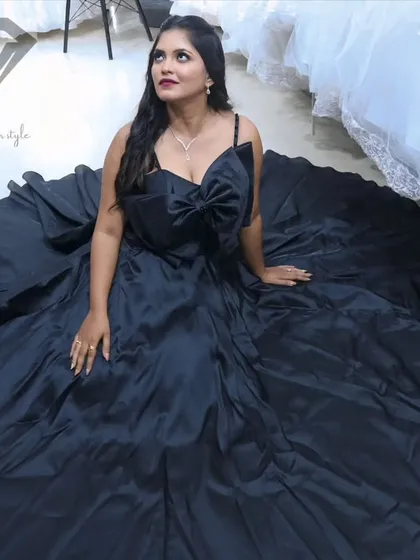 Dare to be dramatic. This black satin ball gown is all about making a bold statement. The voluminous skirt creates a stunning canvas for the oversized architectural bow, a detail I designed for unforgettable impact.