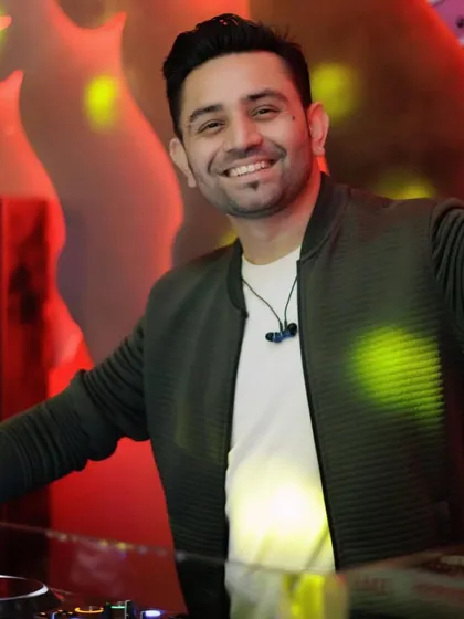A welcoming smile from behind the decks.