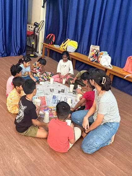 An instructor guides a group of young artists during a hands-on craft session. We keep our groups small to ensure every child gets the attention they need to explore their creative ideas and learn new skills.