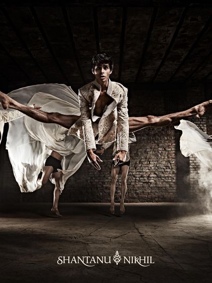 Another image from the Shantanu & Nikhil campaign, showcasing a complex lift and split that highlights both the athleticism of the dancers and the structure of the clothing. This is where fashion photography meets performance art.