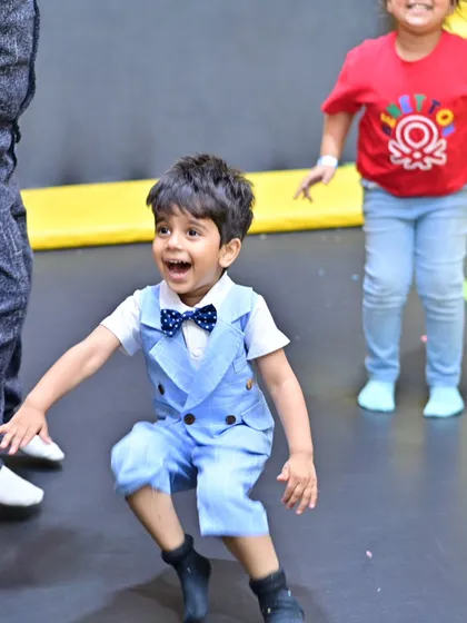 The pure joy of bouncing on a trampoline. This little guest, dressed in his party best, is having an amazing time in our dedicated trampoline park.