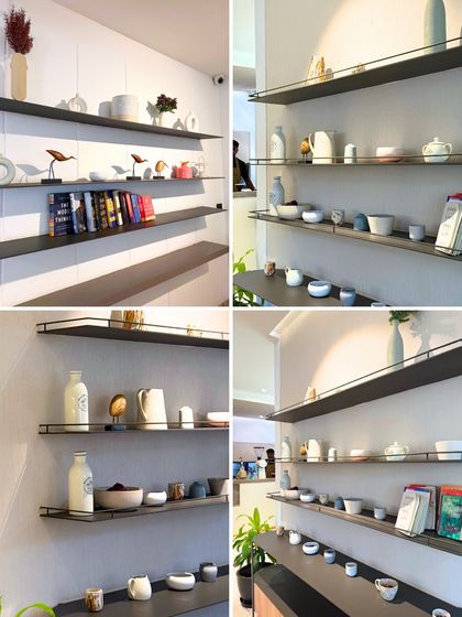 A collage of our shelf decor. We've carefully selected books and pottery to create a space that feels curated yet personal.