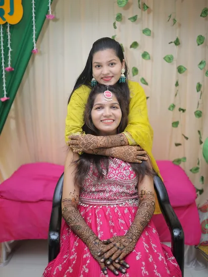 Another lovely photo of the bride with her sister. The bond between them is as beautiful as the henna on their hands.